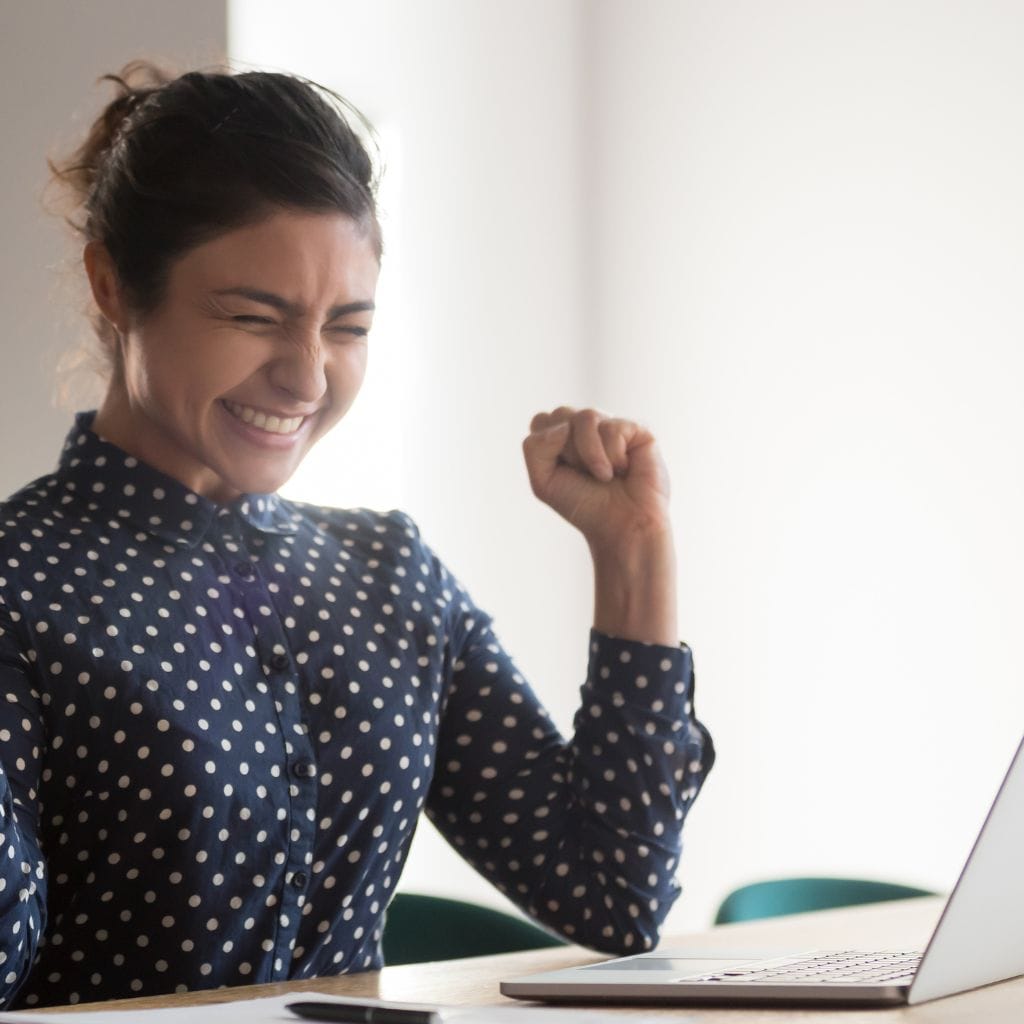 professional women celebrating with computer